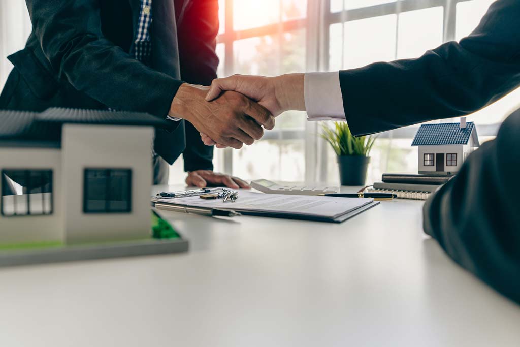 A man shaking hands with a real estate agent 